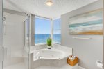 Large walk-in shower and tub with a view 